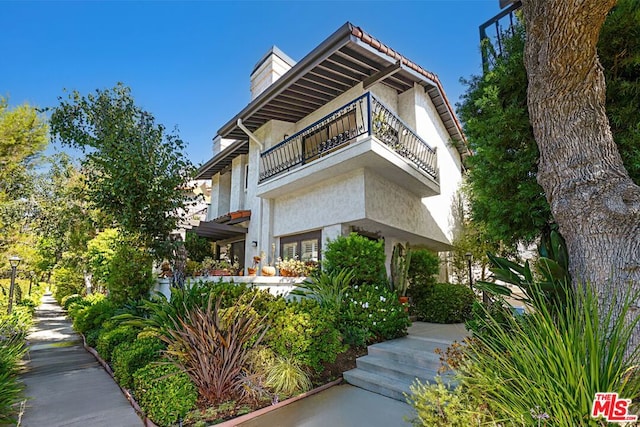 view of property exterior with a balcony