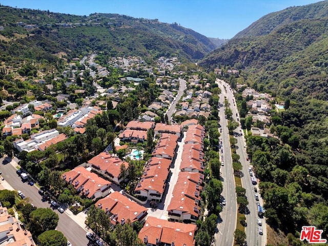 birds eye view of property with a mountain view