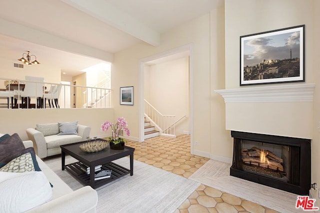 living room featuring beamed ceiling, a chandelier, and light tile patterned floors