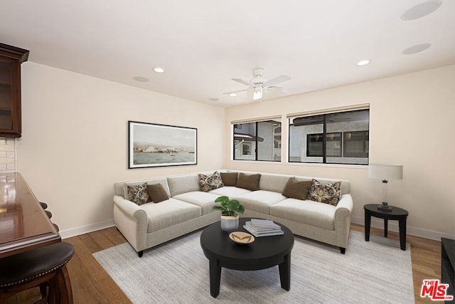 living room featuring ceiling fan and light wood-type flooring