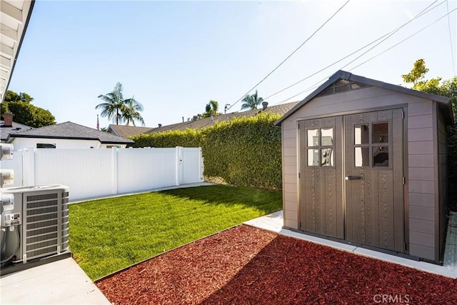 view of yard with a shed and central AC unit