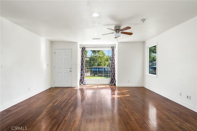 spare room featuring ceiling fan, a healthy amount of sunlight, and wood-type flooring