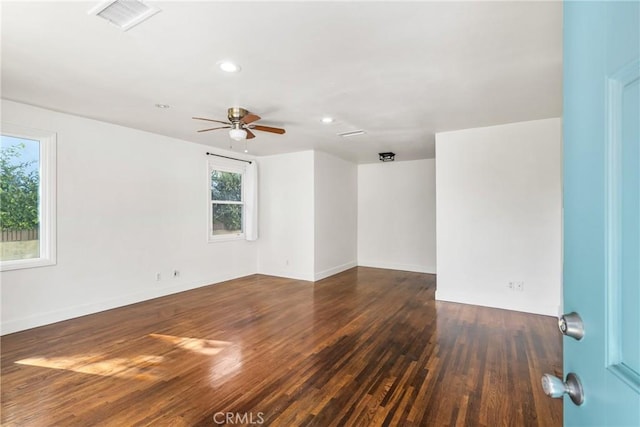 spare room with ceiling fan and dark hardwood / wood-style flooring