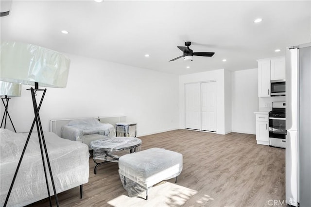 interior space featuring light wood-type flooring and ceiling fan