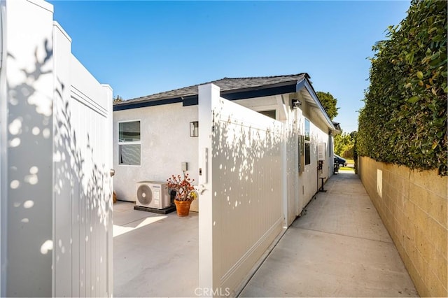 view of property exterior featuring ac unit and a patio area