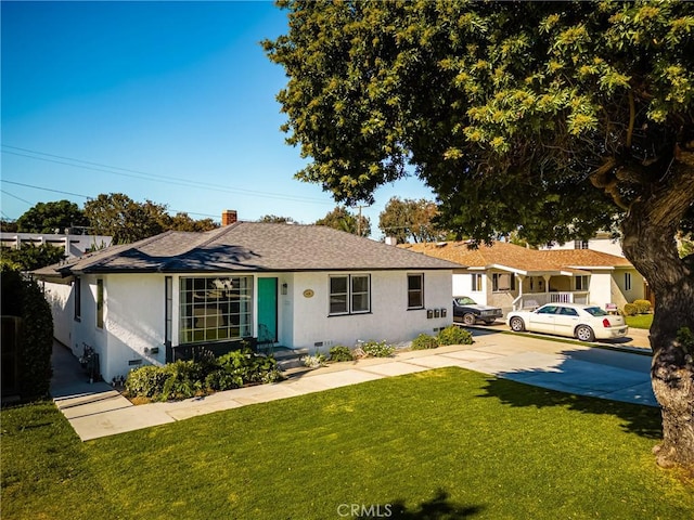 ranch-style home with a front lawn