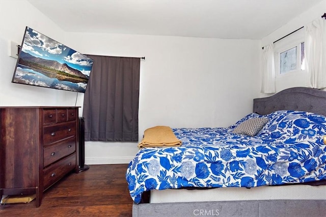 bedroom with dark wood-type flooring