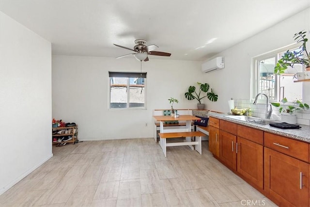 kitchen with a wall mounted air conditioner, backsplash, ceiling fan, and sink