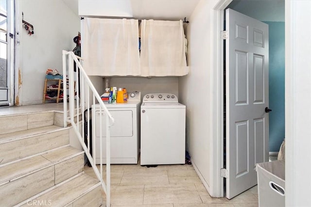 laundry room with cabinets and washing machine and clothes dryer