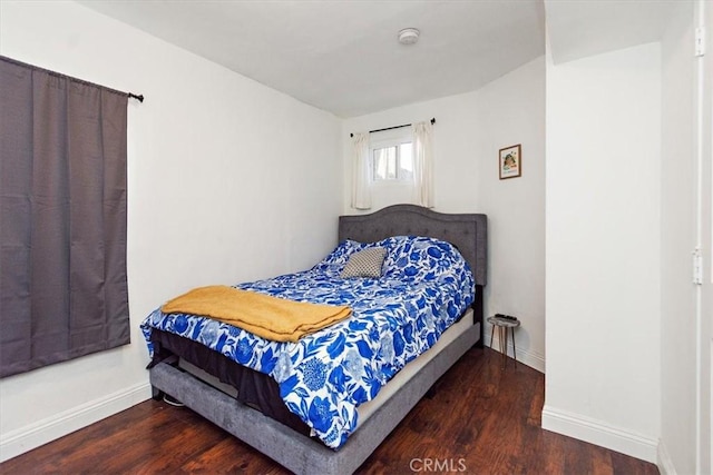 bedroom with dark hardwood / wood-style floors