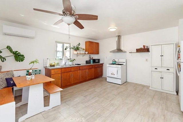 kitchen featuring ceiling fan, wall chimney exhaust hood, a wall mounted air conditioner, white appliances, and decorative backsplash