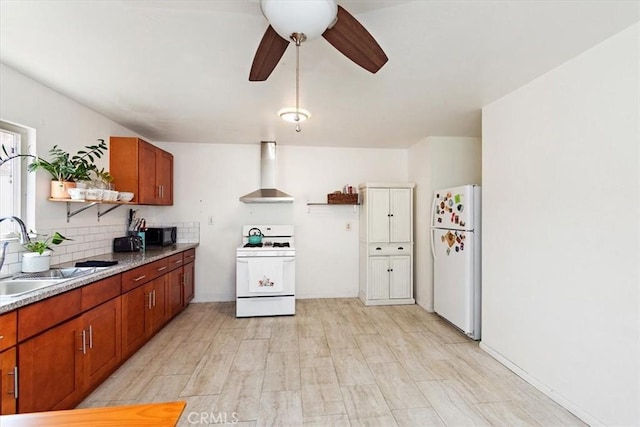 kitchen with backsplash, wall chimney exhaust hood, white appliances, ceiling fan, and sink