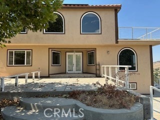 rear view of house featuring a patio area and french doors