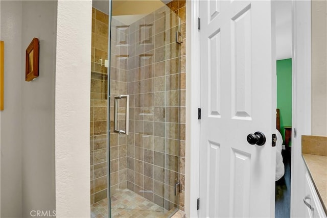 bathroom with vanity and a shower with door