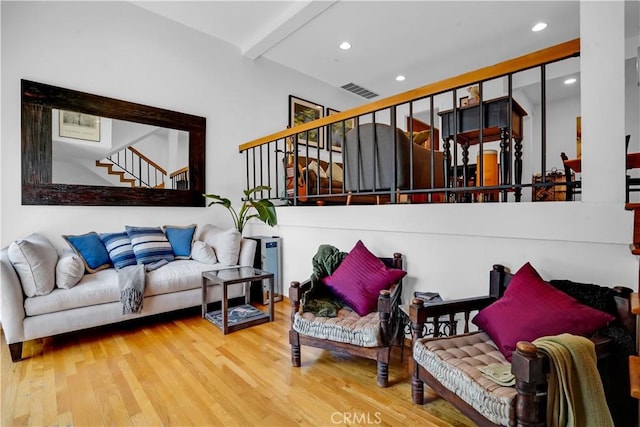 living room with hardwood / wood-style floors and beam ceiling