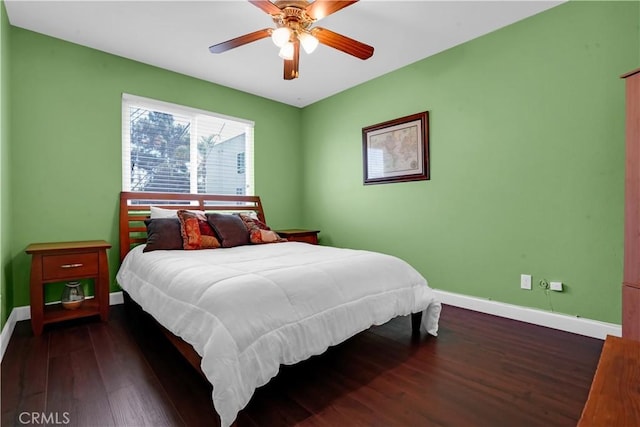 bedroom with ceiling fan and dark hardwood / wood-style floors