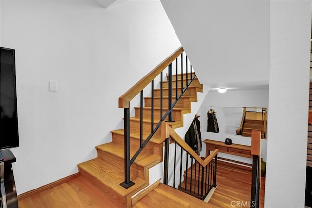 stairs with wood-type flooring