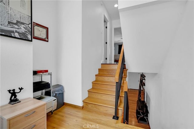 stairs featuring hardwood / wood-style flooring