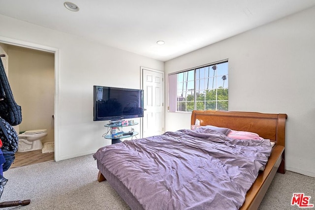 carpeted bedroom with ensuite bathroom