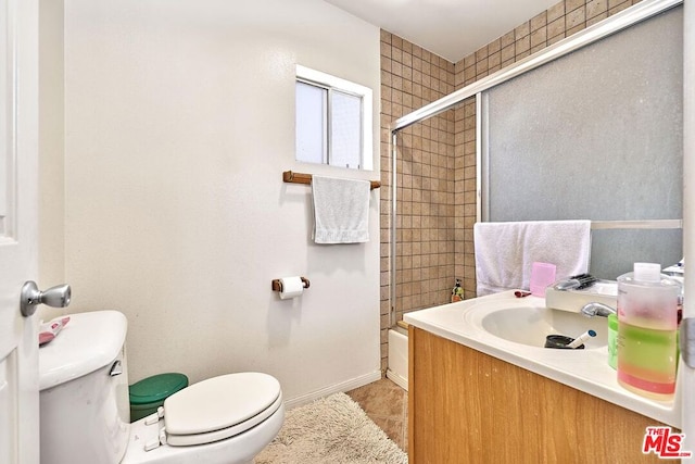 full bathroom with enclosed tub / shower combo, tile patterned flooring, vanity, and toilet