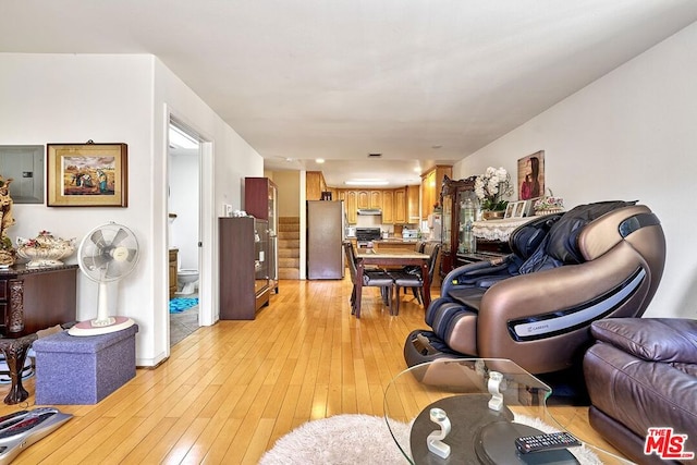 living room with electric panel and light hardwood / wood-style floors