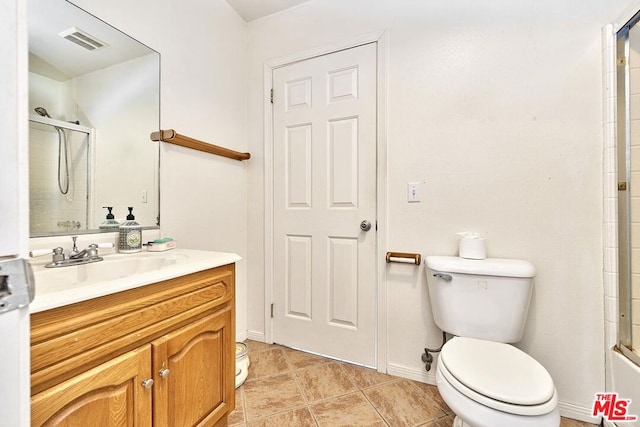 bathroom with vanity, toilet, and an enclosed shower