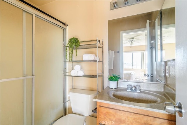 bathroom featuring vanity, ceiling fan, and toilet