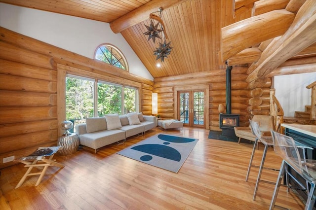 living room featuring wood ceiling, wood-type flooring, beamed ceiling, and a healthy amount of sunlight