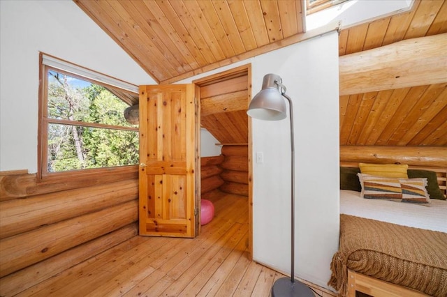 bonus room with log walls, vaulted ceiling with skylight, and wood ceiling