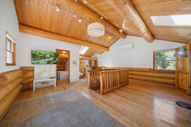 additional living space featuring an AC wall unit, hardwood / wood-style flooring, wooden ceiling, and lofted ceiling with skylight