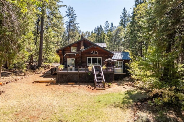 back of property featuring a wooden deck