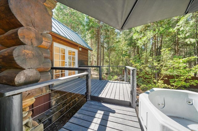 wooden terrace featuring a hot tub