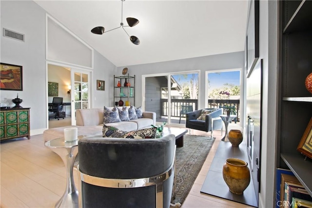 living room featuring high vaulted ceiling and light hardwood / wood-style floors