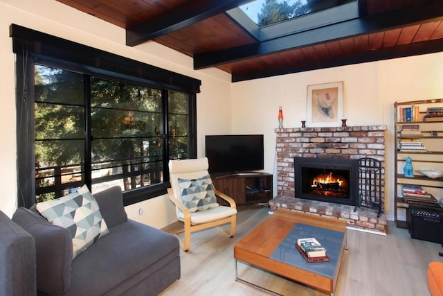 living room with a fireplace, beam ceiling, hardwood / wood-style flooring, and wood ceiling