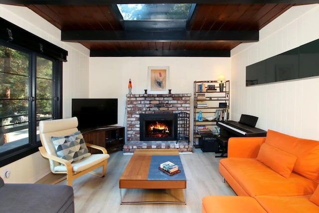 living room with beamed ceiling, wooden ceiling, and light hardwood / wood-style flooring