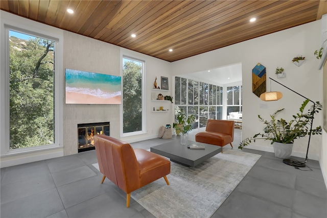 sunroom / solarium with a fireplace and wooden ceiling