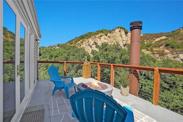 balcony featuring an outdoor fire pit