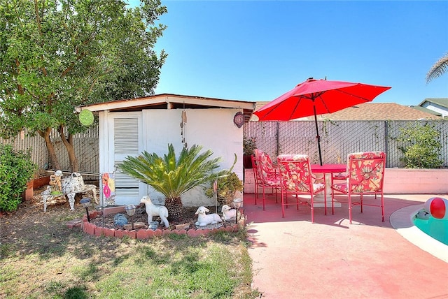 view of patio with a storage shed