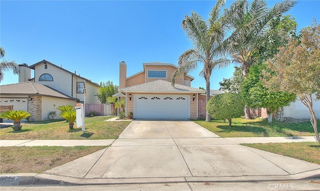 view of property with a front lawn and a garage