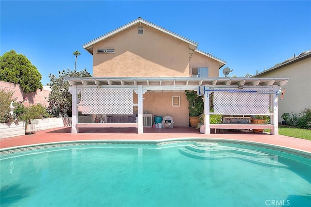 rear view of house featuring a patio area and a pergola