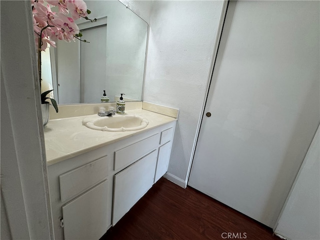 bathroom with vanity and hardwood / wood-style flooring