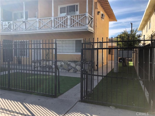 view of gate with a lawn