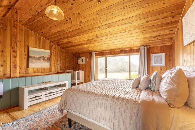 bedroom with vaulted ceiling and wood walls