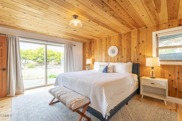 bedroom with light wood-type flooring, access to outside, multiple windows, and wooden ceiling