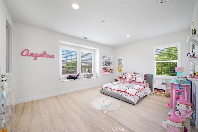 bedroom featuring light hardwood / wood-style floors and multiple windows