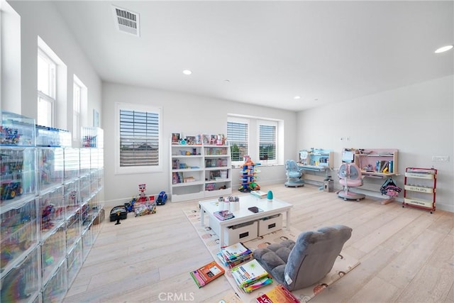 game room with light hardwood / wood-style flooring