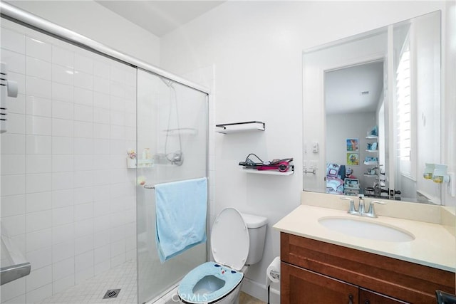 bathroom with toilet, vanity, and walk in shower