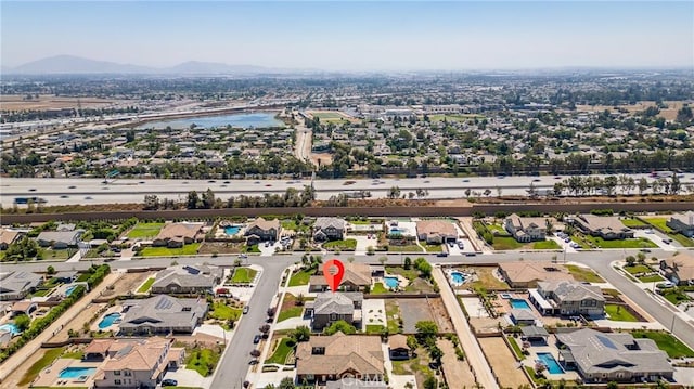 birds eye view of property featuring a water and mountain view