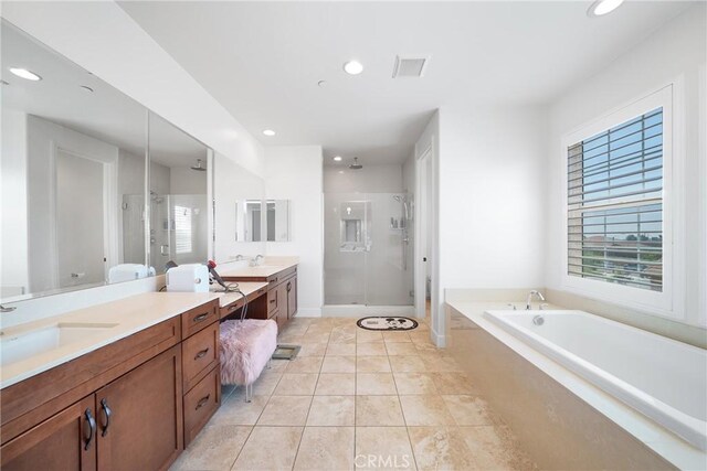 bathroom with tile patterned floors, vanity, and separate shower and tub