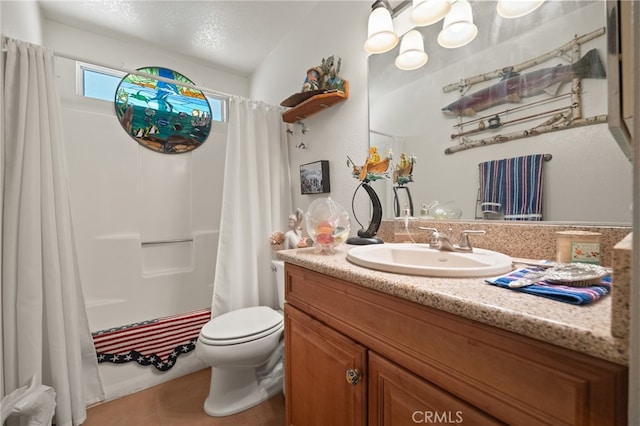 bathroom featuring vanity, tile patterned flooring, toilet, and a textured ceiling